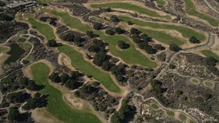 AX0005_012E - 5K aerial stock footage of orbiting a golf course in Canyon Country, California