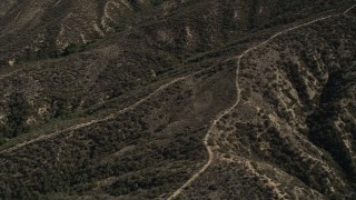 AX0005_015 - 5K aerial stock footage of orbiting dirt roads up ridges in the San Gabriel Mountains, California