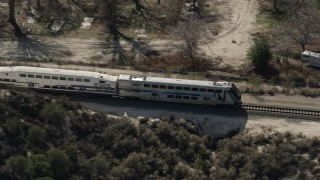 AX0005_025E - 5K aerial stock footage track passenger train in Santa Clarita, California