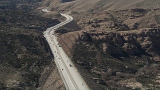 AX0005_037 - 5K aerial stock footage of light traffic on Highway 14 through the Mojave Desert, California