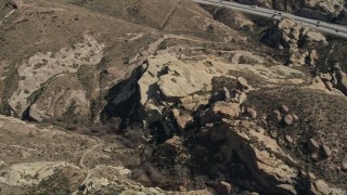 AX0005_043 - 5K aerial stock footage of Mojave Desert rock formations in California