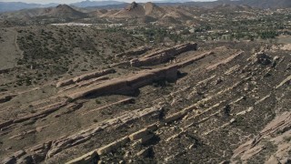 AX0005_044 - 5K aerial stock footage of layers of desert rock formations at Vasquez Rocks Park, California