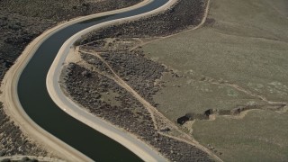 AX0005_064 - 5K aerial stock footage fly over the curves in a desert aqueduct in the Mojave Desert of California