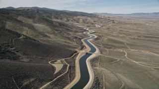 AX0005_065 - 5K aerial stock footage of California Aqueduct in the Mojave Desert of California