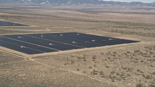 AX0005_076E - 5K aerial stock footage of a solar panel array in the desert of Antelope Valley, California