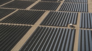 AX0005_079 - 5K aerial stock footage of an orbit of solar array panels in the desert of Antelope Valley, California