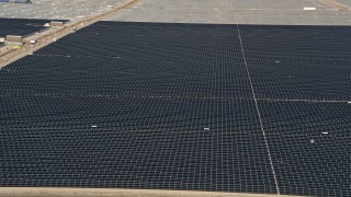 AX0005_087 - 5K stock footage aerial video orbit panels in a solar energy array in the Mojave Desert, California