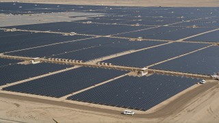 AX0005_088E - 5K stock footage aerial video of circling solar panels at a solar energy farm in the Mojave Desert, California