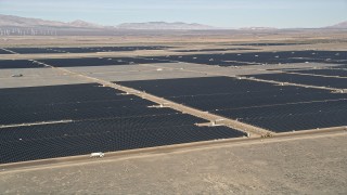 AX0005_092 - 5K stock footage aerial video orbiting Mojave Desert solar energy array in California