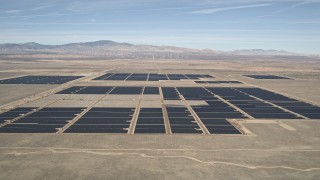 AX0005_103 - 5K aerial stock footage approach Mojave Desert solar energy array in California