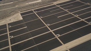 AX0005_110 - 5K stock footage aerial video orbiting panels at a Mojave Desert solar array in California
