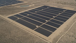 AX0005_112 - 5K aerial stock footage of solar panels at an energy array in the Mojave Desert, California