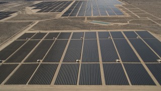 AX0005_113 - 5K stock footage aerial video approach and fly over solar panels at an array in the Mojave Desert, California