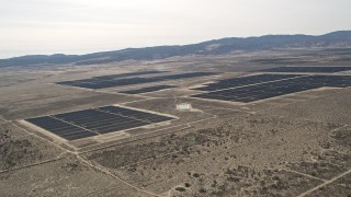 AX0005_115 - 5K aerial stock footage of a large solar energy array in the Mojave Desert, California