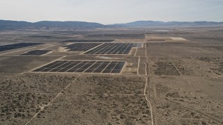 AX0005_117 - 5K aerial stock footage flyby Mojave Desert solar energy array in California