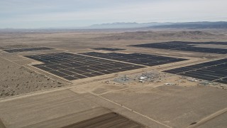 AX0005_123 - 5K stock footage aerial video orbiting a massive desert solar energy array in Antelope Valley, California