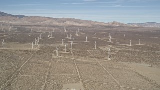 AX0005_124 - 5K aerial stock footage approach a field of windmills in the Mojave Desert, California
