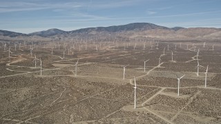 AX0005_125 - 5K aerial stock footage of a field of windmills in the Mojave Desert, California