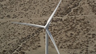 AX0005_126E - 5K aerial stock footage orbit single windmill in the Mojave Desert, California