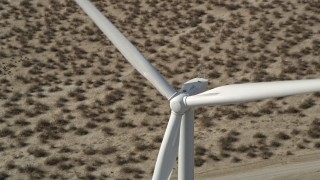 AX0005_133 - 5K aerial stock footage of flying over the top of a windmill in the California, Mojave Desert