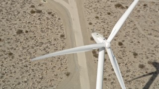 AX0005_134 - 5K aerial stock footage fly over blades of a windmill in the Mojave Desert, California