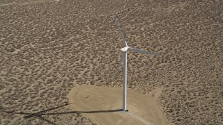 AX0005_141 - 5K aerial stock footage orbit lone windmill in the California Desert