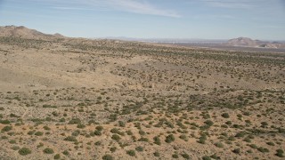 AX0005_147 - 5K aerial stock footage of flying low over open desert in Antelope Valley, California