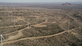 AX0006_027 - 5K aerial stock footage of a large desert wind farm in Antelope Valley, California