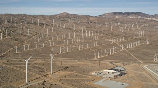 AX0006_043 - 5K aerial stock footage of rows of windmills at a wind energy farm in the Mojave Desert of California