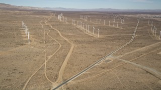 AX0006_048 - 5K aerial stock footage approach three rows of windmills at a wind energy farm in the California desert