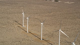 AX0006_051 - 5K aerial stock footage approach four windmills at a desert wind farm in Antelope Valley, California