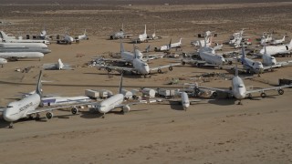 AX0006_066E - 5K stock footage aerial video of rows of airplanes at an aircraft boneyard in the Mojave Desert, California