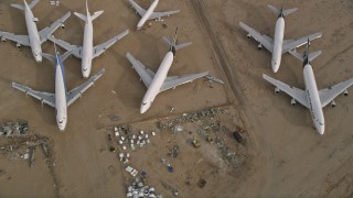 AX0006_090 - 5K stock footage aerial video bird's eye view of a group of airplanes at a boneyard in the desert, Mojave Air and Space Port, California