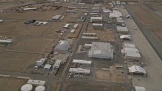 AX0006_091 - 5K aerial stock footage orbit hangars and runways at the Mojave Air and Space Port in California