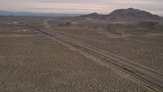 AX0006_098 - 5K aerial stock footage approach Highway 14 in the Mojave Desert, California