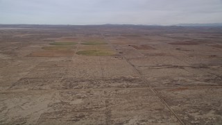 AX0006_102 - 5K aerial stock footage of VFX Background Plate over the Mojave Desert near farmland in California