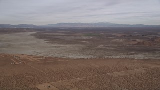 AX0006_130 - 5K aerial stock footage tilt up to reveal a dry lake in the Mojave Desert, California