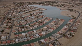 AX0006_166E - 5K aerial stock footage orbit lakeside homes in a small desert town in Helendale, California