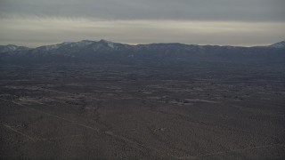 AX0007_020 - 5K aerial stock footage of Background VFX Plate of Mojave Desert and mountains with snow at Sunset, California