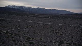 AX0007_042 - 5K aerial stock footage fly over desert roads in Mojave Desert at twilight, California