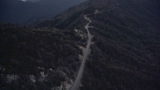 AX0008_039E - 5K aerial stock footage approach a mountain road at twilight in the San Gabriel Mountains, California