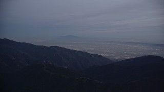 AX0008_048 - 5K aerial stock footage video of San Gabriel Valley beyond the mountains at twilight, California