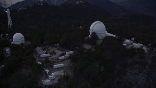 AX0008_050E - 5K aerial stock footage orbit and fly away from the Mount Wilson Observatory at twilight in California