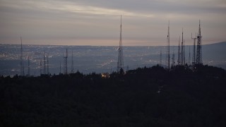 AX0008_054 - 5K aerial stock footage of radio towers atop San Gabriel Mountains at twilight, California