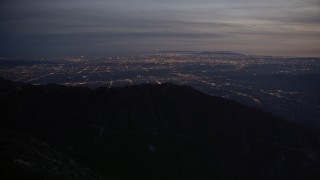 AX0008_061 - 5K aerial stock footage of suburban lights in San Gabriel Valley seen from mountains at twilight, California