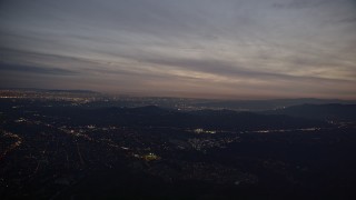 AX0008_063 - 5K aerial stock footage approach Jet Propulsion Lab from San Gabriel Mountains at Night, California