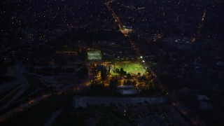 AX0008_065 - 5K aerial stock footage approach baseball field at night in Altadena, California