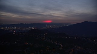 AX0008_071 - 5K aerial stock footage approach red glow in the clouds above La Cañada Flintridge at night, California