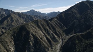 AX0009_011E - 5K aerial stock footage of sharp mountain ridges to reveal road in San Gabriel Mountains of California