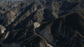 AX0009_018 - Aerial stock footage of 5K aerial  video pan across a lonely road in the San Gabriel Mountains, California